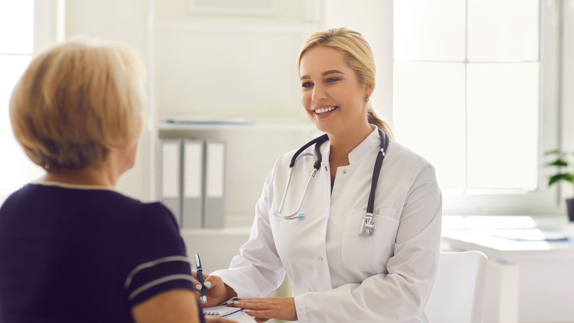 A doctor smiling during a consultation with a patient